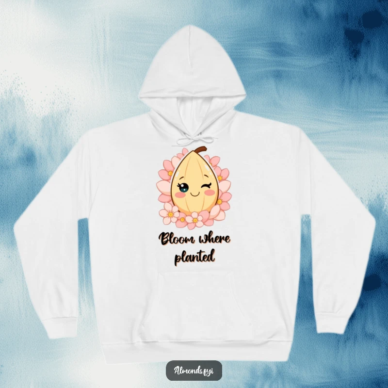 Funny hoodie with a smiling almond character embraced by colorful petals, offering cozy comfort and a cheerful, floral design.