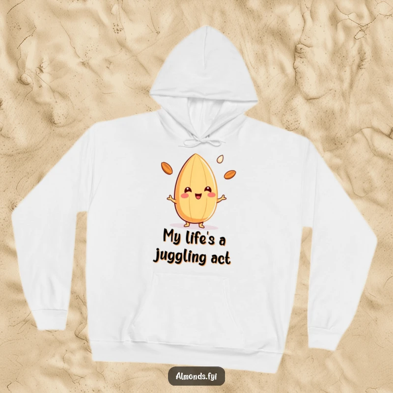 Funny hoodie with a beaming almond character skillfully juggling three little drops of almond milk, radiating happiness and charm.