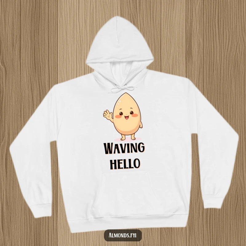 Funny hoodie displaying a chubby, blushing almond character with a friendly wave, perfect for cozy, cheerful moments.