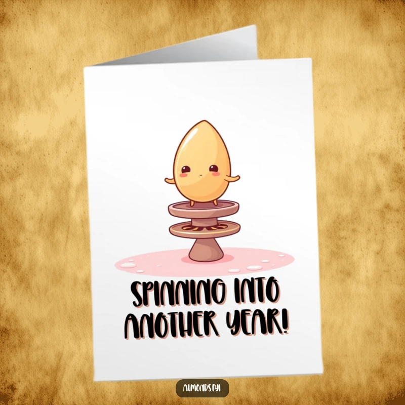 Funny Free Printable Birthday Card: Wobbly almond struggles to balance on a large, colorful spinning sugar top, looking precarious.